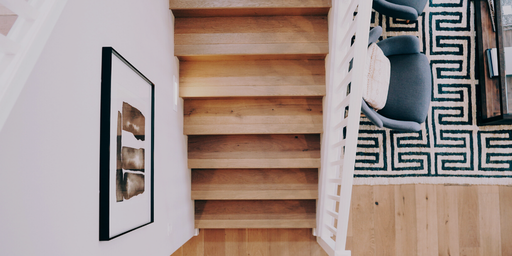 hardwood staircase in modern living room with white oak floors